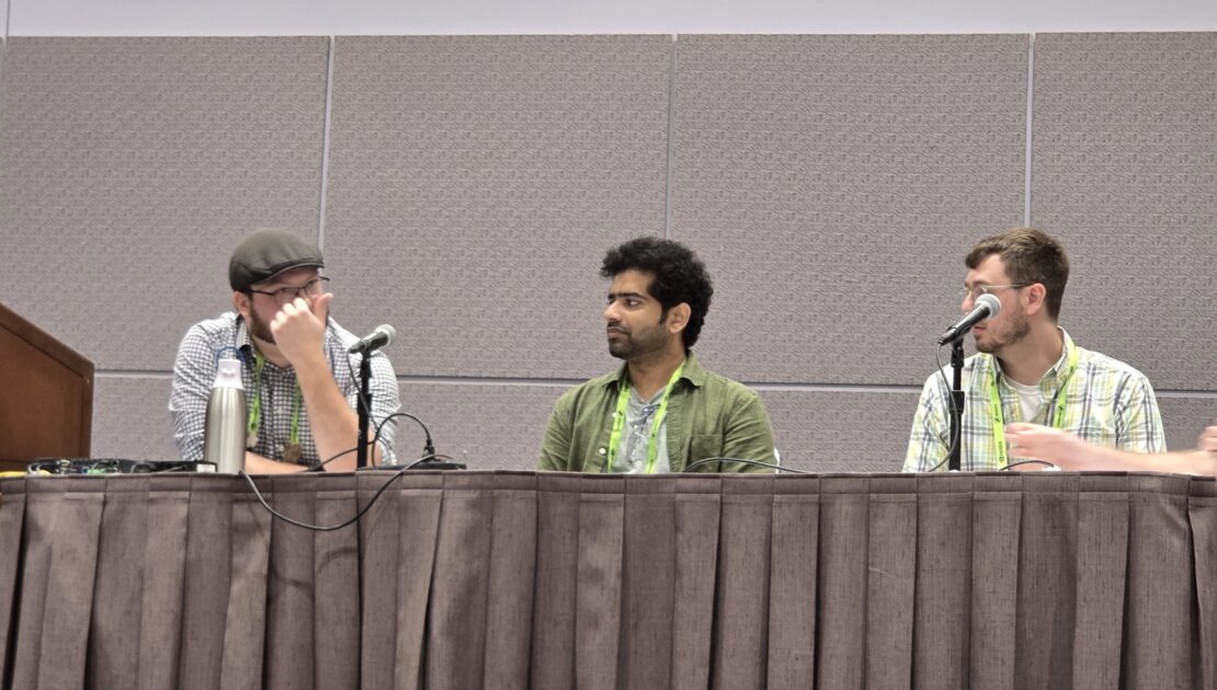 Three panelists seated at a table with microphones during the PRICE Workshop panel discussion